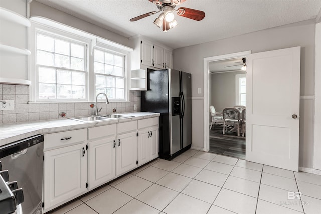 kitchen with stainless steel appliances, ceiling fan, light hardwood / wood-style flooring, white cabinets, and backsplash