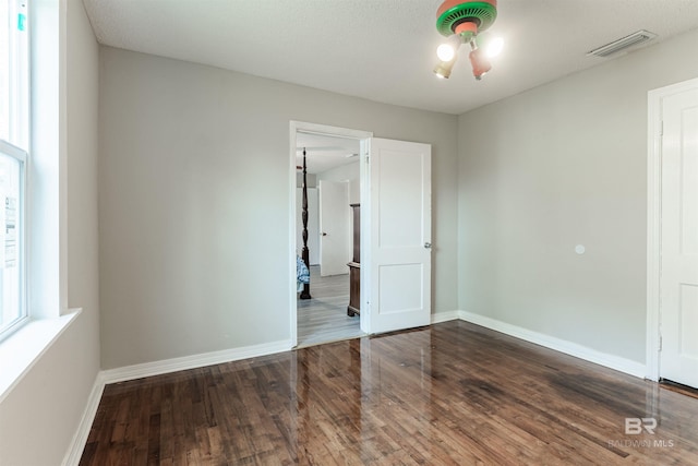 unfurnished room with dark hardwood / wood-style floors