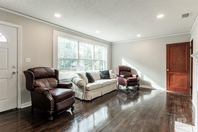 living room featuring ornamental molding, dark wood-type flooring, and a textured ceiling