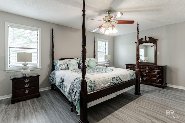 bedroom featuring a textured ceiling, ceiling fan, and hardwood / wood-style flooring