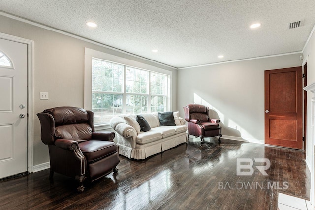 living room featuring crown molding, dark wood-type flooring, and a textured ceiling