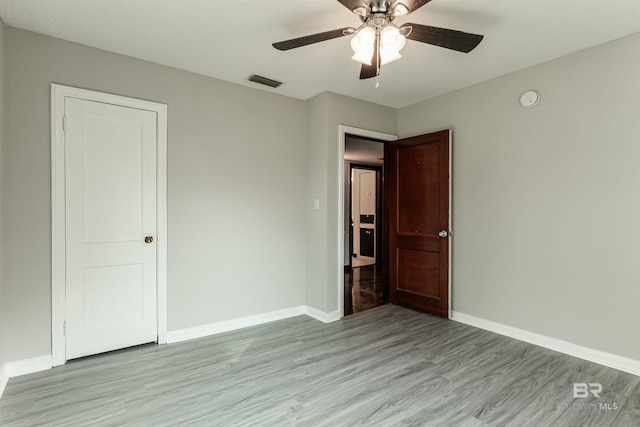 unfurnished bedroom with ceiling fan and light hardwood / wood-style flooring