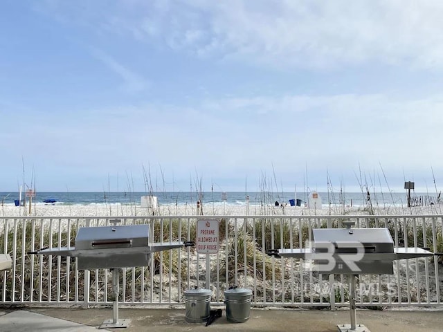 exterior space with a water view and a view of the beach