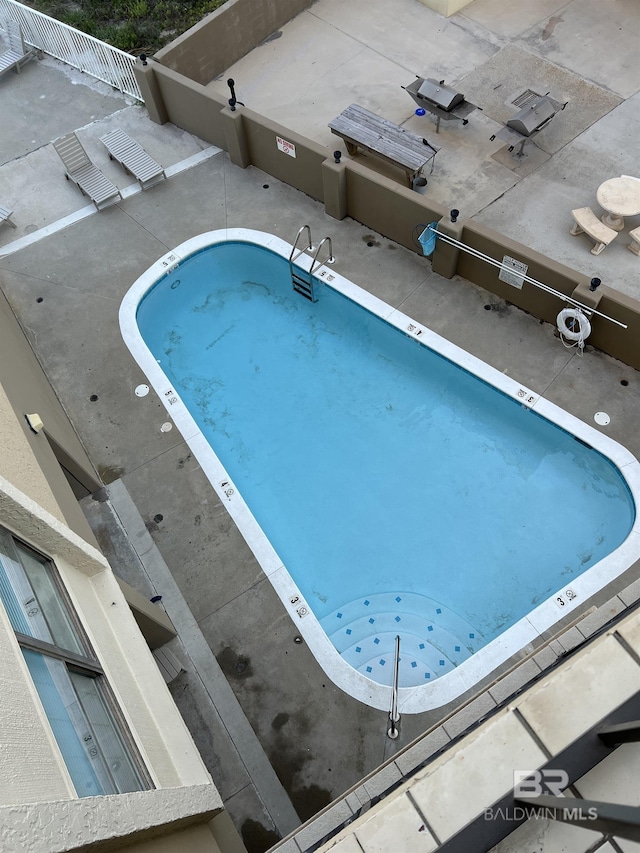 view of swimming pool with fence