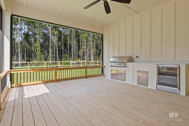 unfurnished sunroom featuring ceiling fan and wine cooler