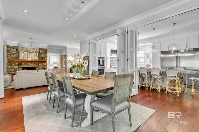 1106 Old County Rd, Daphne, AL 36526 - dining space featuring crown molding, recessed lighting, wood finished floors, and a fireplace
