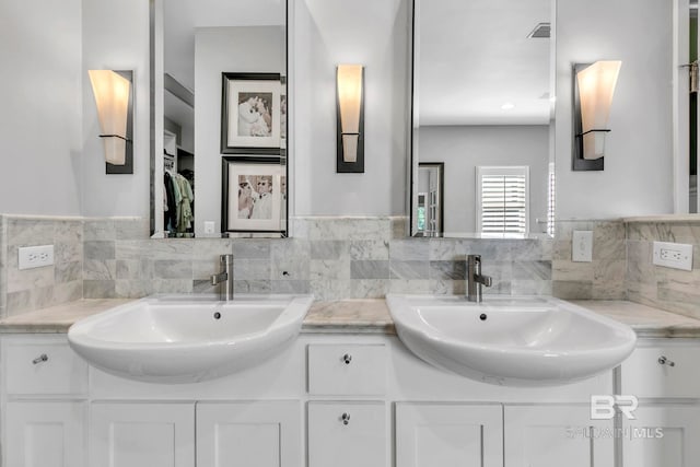 1106 Old County Rd, Daphne, AL 36526 - bathroom featuring double vanity, visible vents, a sink, and tasteful backsplash