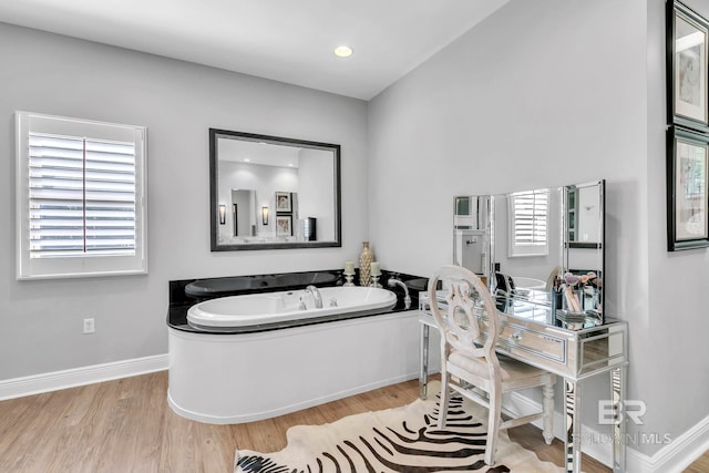 1106 Old County Rd, Daphne, AL 36526 - bathroom with baseboards, a bath, and wood finished floors