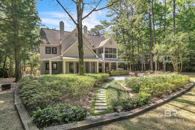 1106 Old County Rd, Daphne, AL 36526 - rear view of property featuring a patio, a chimney, and a sunroom
