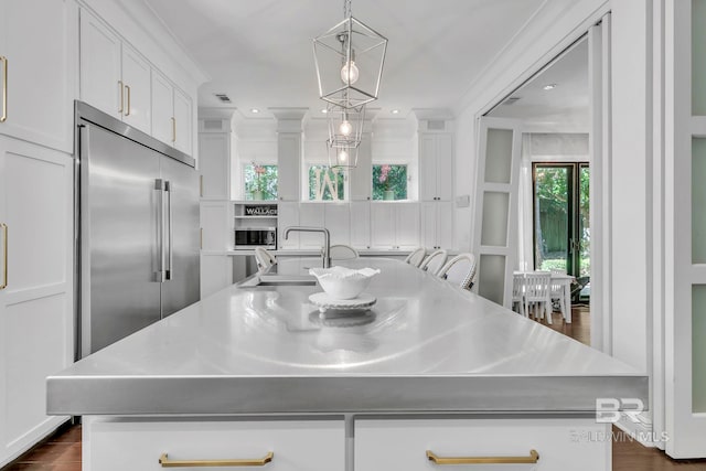 1106 Old County Rd, Daphne, AL 36526 - kitchen with hanging light fixtures, a center island with sink, a sink, built in refrigerator, and white cabinets