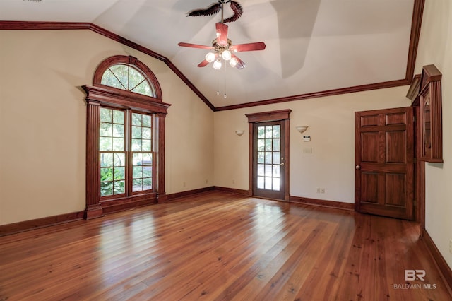 spare room featuring crown molding, lofted ceiling, ceiling fan, and dark hardwood / wood-style floors