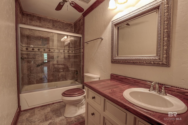 full bathroom with vanity, toilet, ceiling fan, and enclosed tub / shower combo