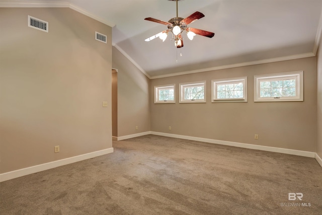 carpeted empty room with ornamental molding, lofted ceiling, and ceiling fan