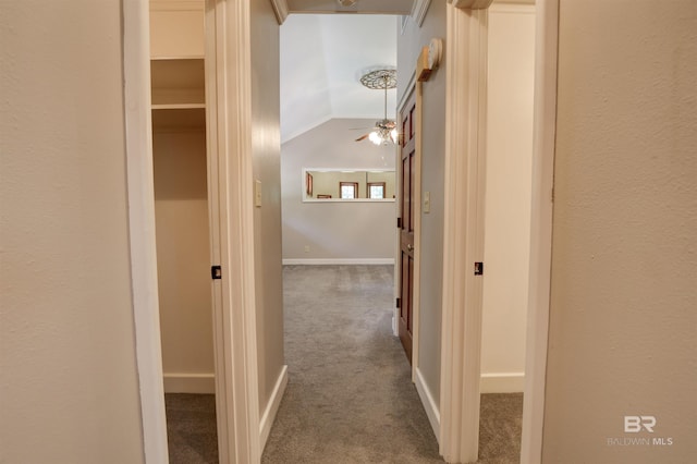 hall with vaulted ceiling and carpet