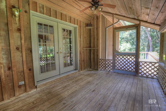 unfurnished sunroom featuring lofted ceiling, ceiling fan, and wooden ceiling