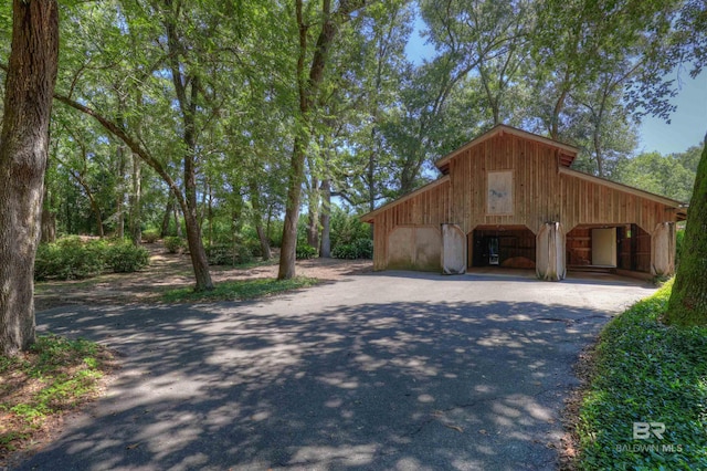 view of home's exterior featuring an outdoor structure and a garage