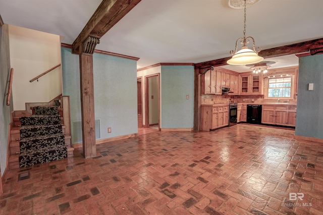 unfurnished living room with sink, beamed ceiling, and decorative columns