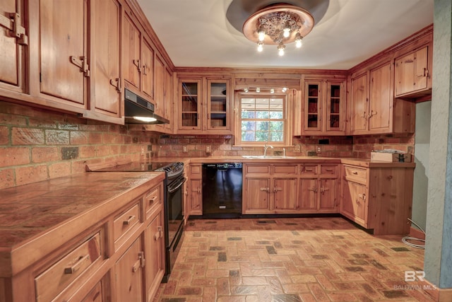 kitchen with black appliances, an inviting chandelier, backsplash, and sink