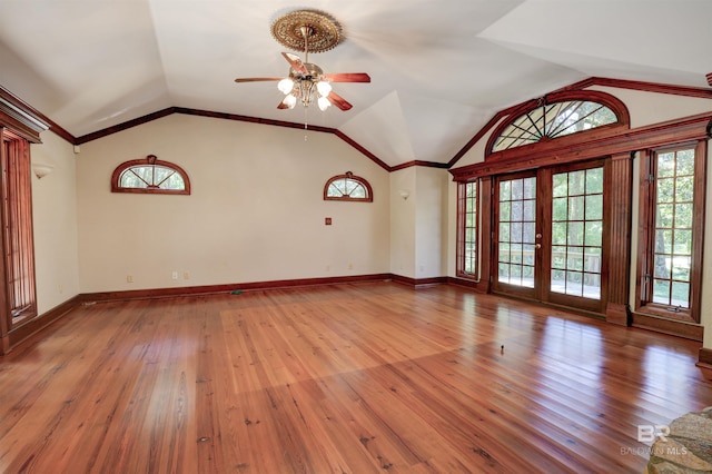 unfurnished living room featuring lofted ceiling, light hardwood / wood-style flooring, and ceiling fan