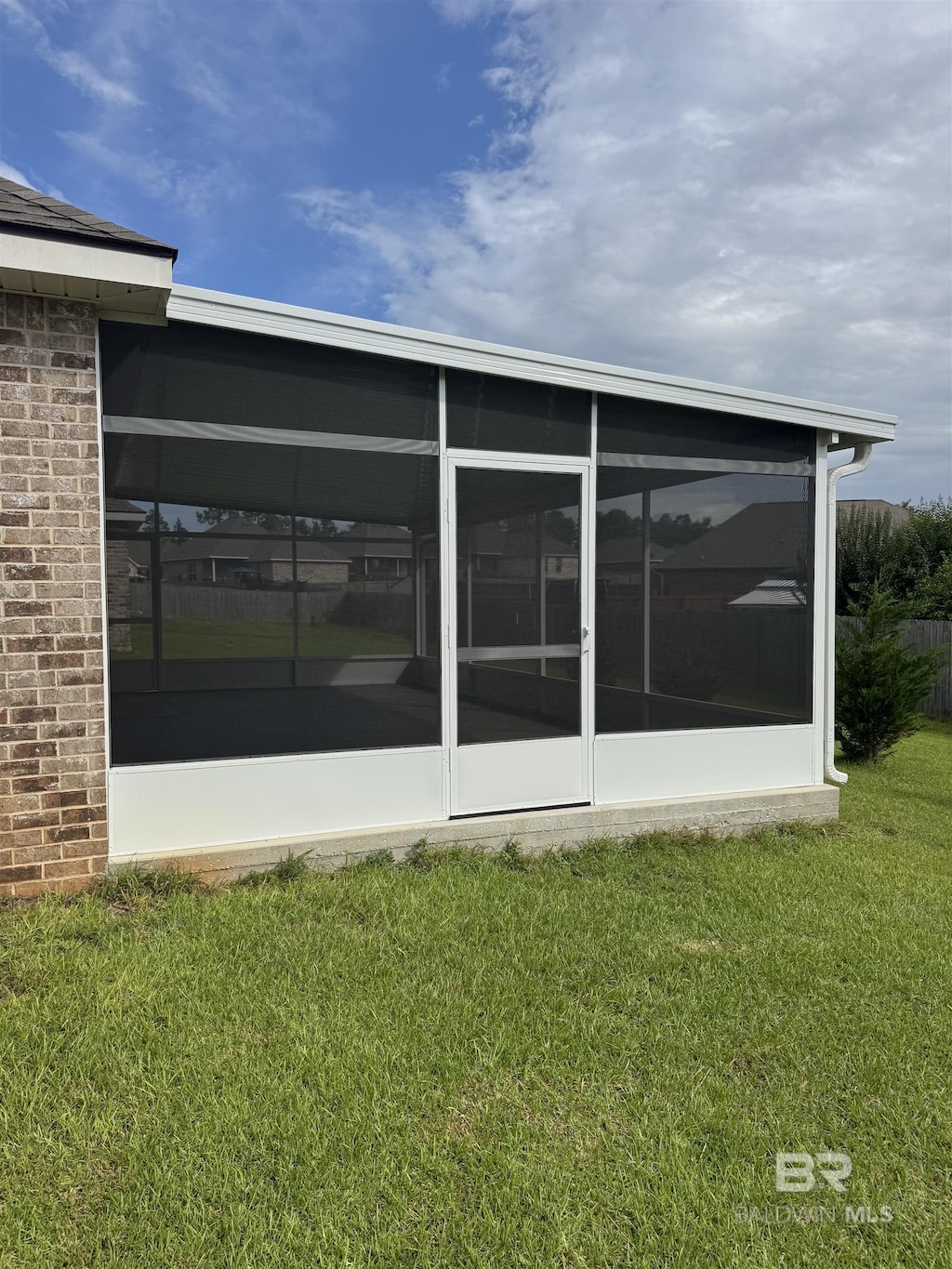 10714 Brodick Loop, Spanish Fort, AL 36527 - back of property with a yard, a sunroom, and brick siding