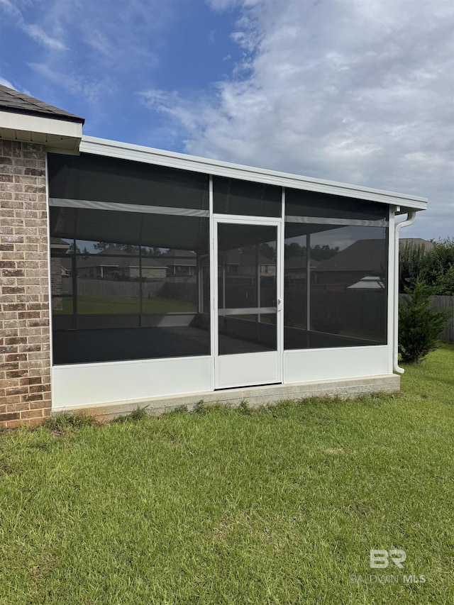 10714 Brodick Loop, Spanish Fort, AL 36527 - back of property with a yard, a sunroom, and brick siding