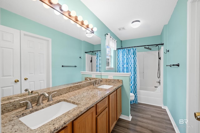 bathroom featuring visible vents, shower / bath combination with curtain, toilet, and a sink