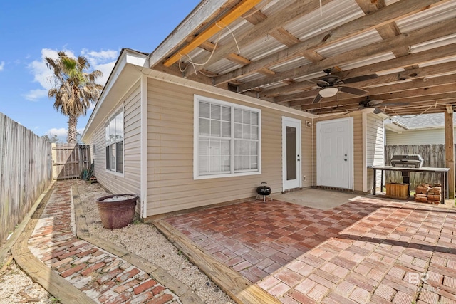 view of patio featuring area for grilling, a fenced backyard, and ceiling fan