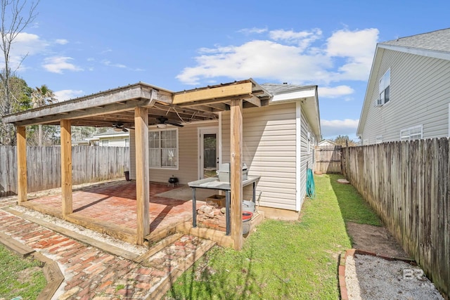 exterior space featuring a ceiling fan and a fenced backyard