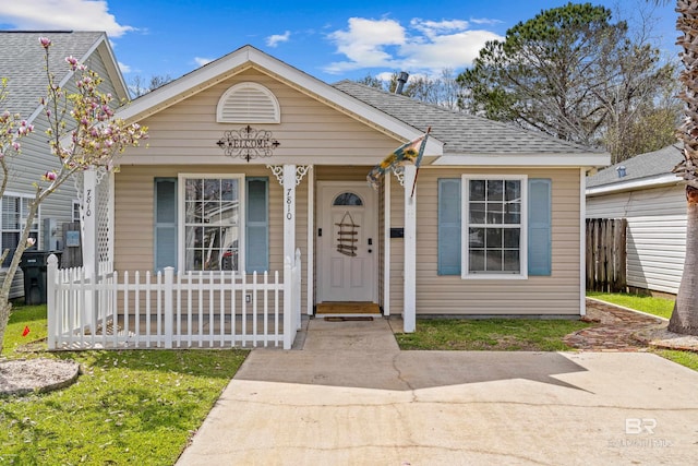 view of front of house featuring a porch, fence, and roof with shingles