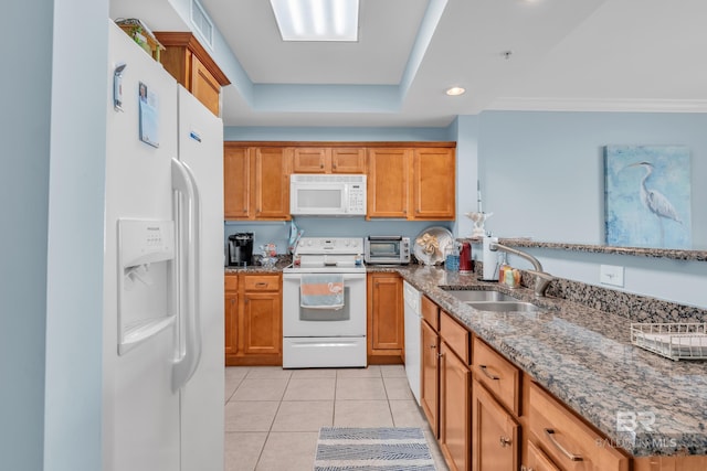 453 Dune Dr Unit 305, Gulf Shores, AL 36542 - kitchen featuring white appliances, a sink, stone counters, light tile patterned flooring, and brown cabinets