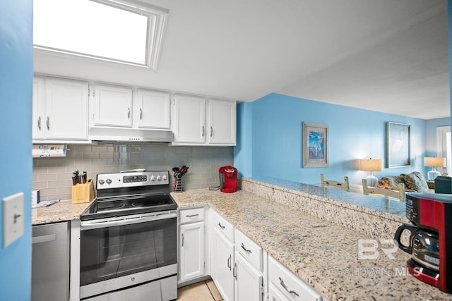 327 E Beach Blvd Unit 7C, Gulf Shores, AL 36542 - kitchen with stainless steel range with electric stovetop, under cabinet range hood, white cabinets, and tasteful backsplash