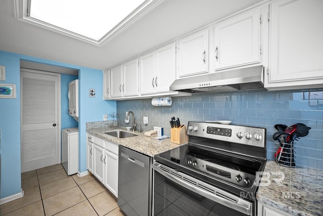 327 E Beach Blvd Unit 7C, Gulf Shores, AL 36542 - kitchen featuring appliances with stainless steel finishes, under cabinet range hood, a sink, white cabinets, and light tile patterned floors