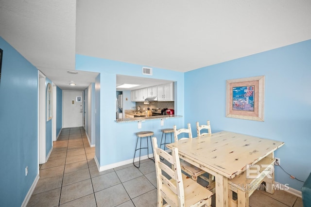 327 E Beach Blvd Unit 7C, Gulf Shores, AL 36542 - dining space featuring light tile patterned flooring and baseboards