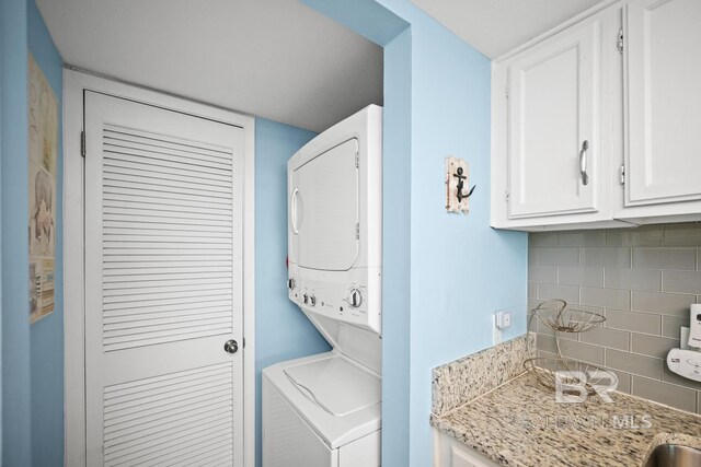 327 E Beach Blvd Unit 7C, Gulf Shores, AL 36542 - laundry area featuring estacked washer and dryer