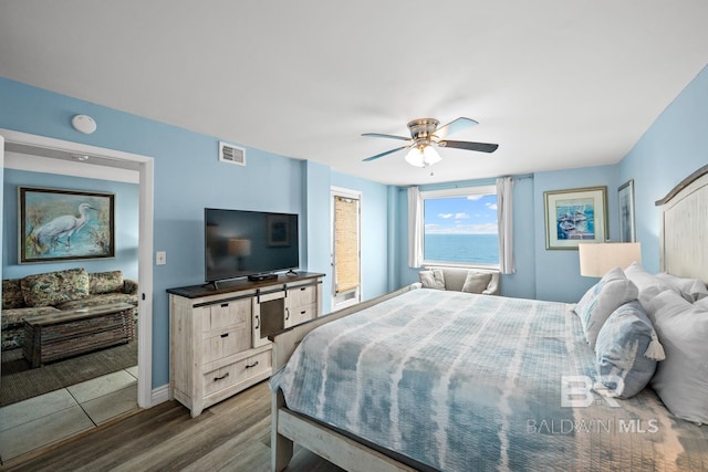 327 E Beach Blvd Unit 7C, Gulf Shores, AL 36542 - bedroom featuring wood finished floors, ceiling fan, and baseboards
