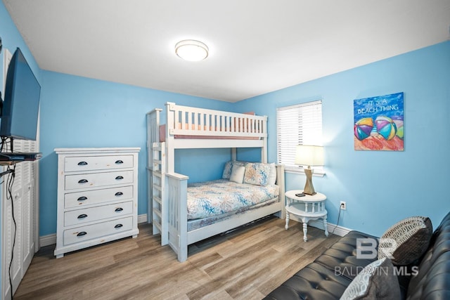 327 E Beach Blvd Unit 7C, Gulf Shores, AL 36542 - bedroom featuring wood finished floors and baseboards