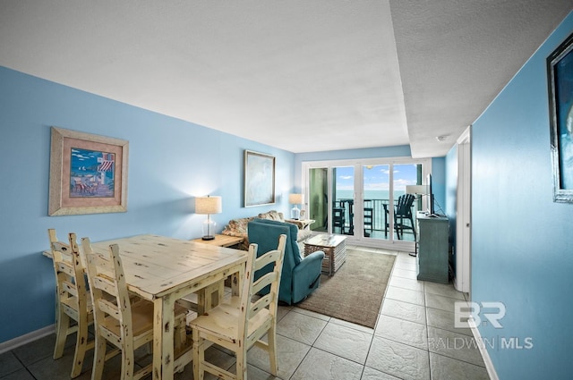 327 E Beach Blvd Unit 7C, Gulf Shores, AL 36542 - dining area with light tile patterned floors and baseboards