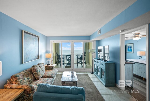 327 E Beach Blvd Unit 7C, Gulf Shores, AL 36542 - living room with light tile patterned floors and a ceiling fan
