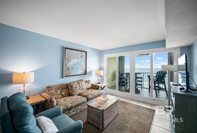 327 E Beach Blvd Unit 7C, Gulf Shores, AL 36542 - living room featuring light tile patterned floors and a textured ceiling