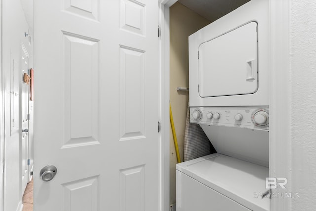 washroom with stacked washer and clothes dryer
