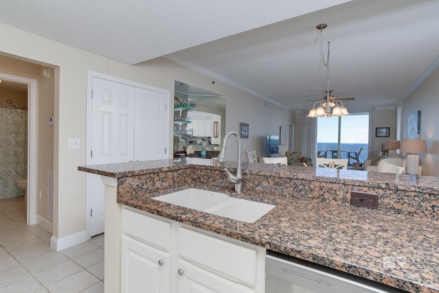 kitchen featuring sink, crown molding, dishwasher, a textured ceiling, and white cabinets