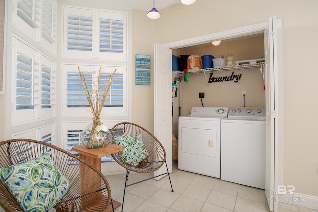 clothes washing area with light tile patterned flooring and independent washer and dryer