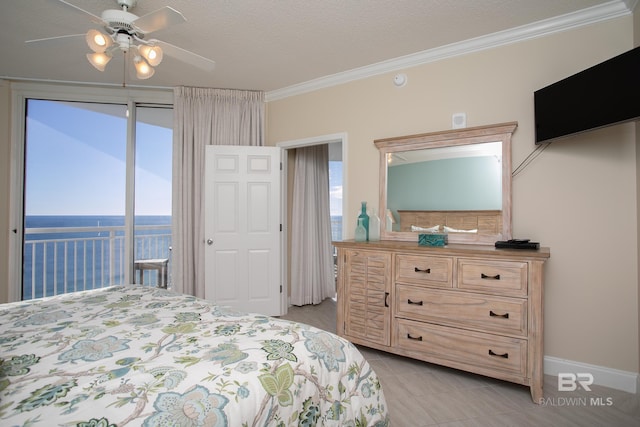 bedroom with access to exterior, ornamental molding, ceiling fan, and a water view