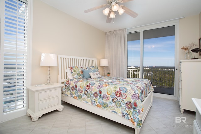 tiled bedroom with access to outside and ceiling fan