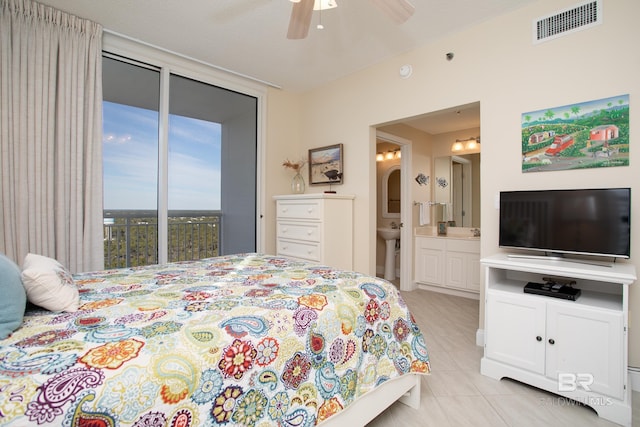 tiled bedroom featuring ensuite bath, access to outside, and ceiling fan