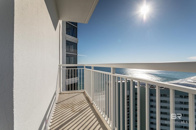 balcony with a water view and a beach view