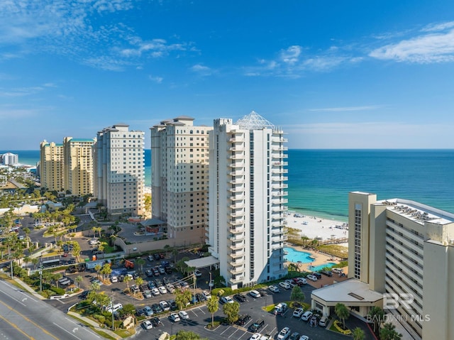 drone / aerial view featuring a water view and a view of the beach