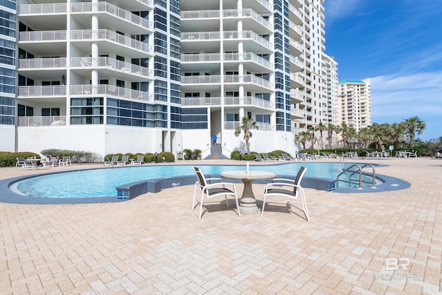 view of swimming pool featuring a patio area