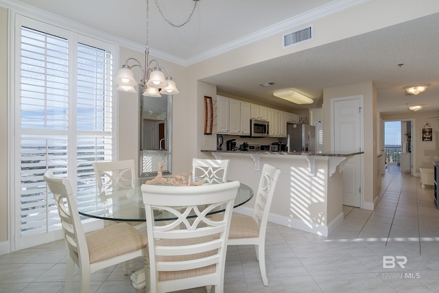 tiled dining space with crown molding, a chandelier, a textured ceiling, and a wealth of natural light