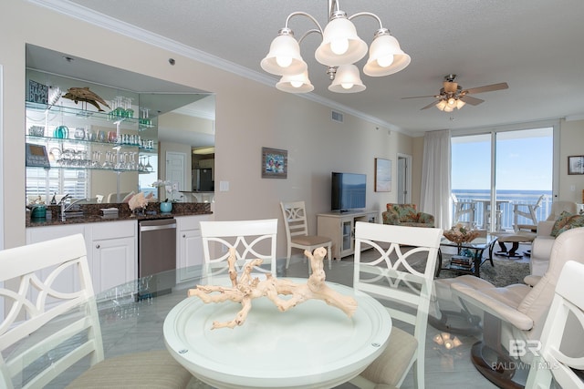 dining area featuring a healthy amount of sunlight, ceiling fan with notable chandelier, and a textured ceiling